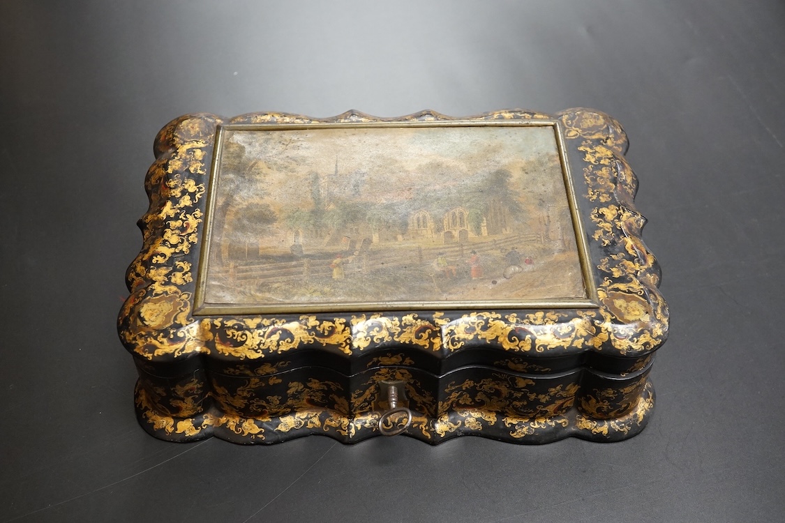 A Victorian Papier mache japanned sewing box, stamped ‘Lane, Birmingham’, the cover with a view of Chingford old church Essex, a boxed Victorian French translation game, by E C Spurin and a papier mache panel (3)